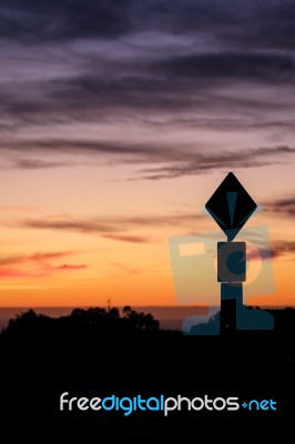 Road Sign Silhouette And Colorful Sunset Stock Photo