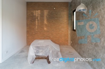 Room Interior In Renovation  With Cement Floor And Red Brick Wal… Stock Photo