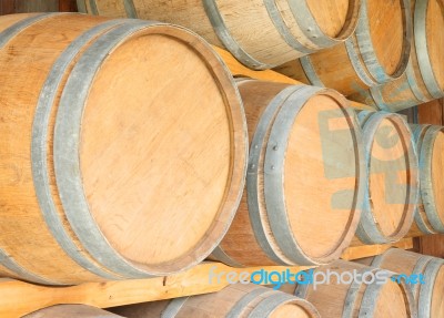 Round Wooden Wine Barrels In Cellar Shelf Stock Photo