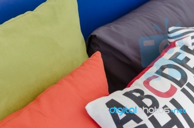Row Of Colorful Pillows On Bed Stock Photo