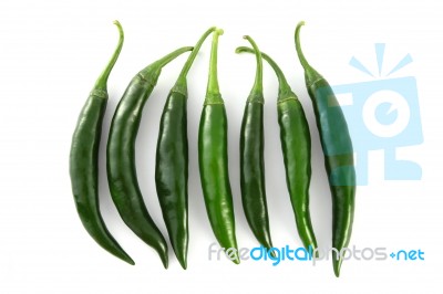 Row Of Green Chili On White Background Stock Photo