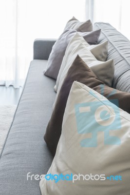 Row Of Pillows On Modern Grey Sofa Stock Photo