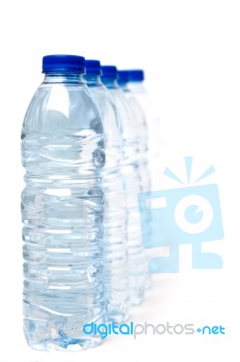 Row Of Plastic Water Bottles Isolated On A White Background Stock Photo