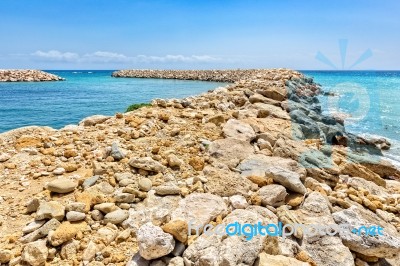 Row Of Stones As  Weir In Greek Sea Stock Photo