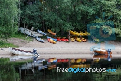 Rowing Boats Moored On Loch Insh Stock Photo