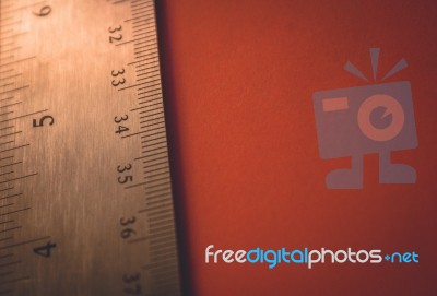 Ruler On The Edge Of A Red Paper Mathematics Background Stock Photo