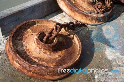 Rusting Anchors And Chains At Lyme Regis Harbour Stock Photo