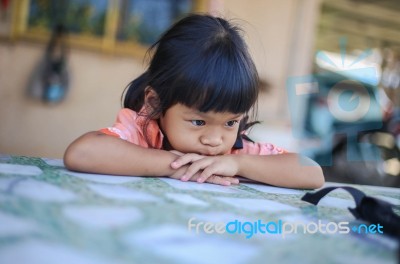Sad Little Girl Holding Her Face Stock Photo