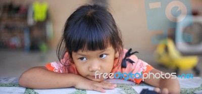 Sad Little Girl Holding Her Face Stock Photo