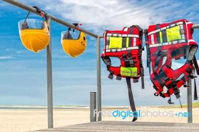 Safety Helmets And Life Jackets Hanging On Railing Stock Photo