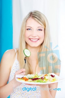 Salad On Fork And Plate Stock Photo