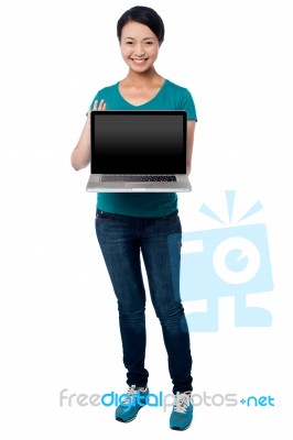 Salesgirl Presenting Brand New Laptop For Sale Stock Photo