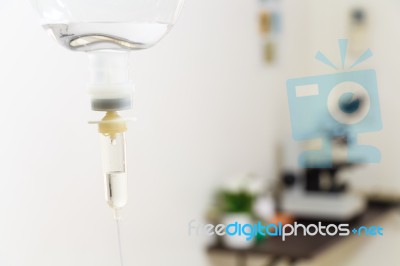 Saline Solution And Microscope In Hospital Stock Photo
