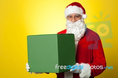 Santa Claus Delivering Big Green Gift Box Stock Photo