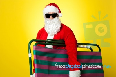 Santa Claus Going To Relax Holding Chair Stock Photo