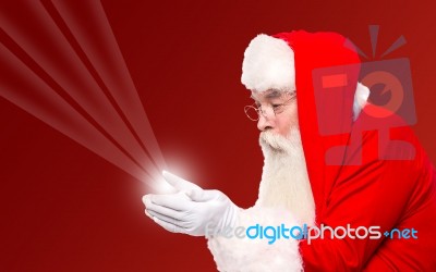 Santa Holding Magical Lights In Hands Stock Photo