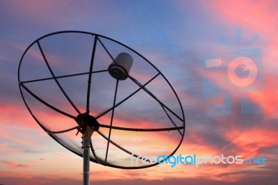 Satellite Dish In Twilight Sky Stock Photo