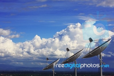 Satellite Dishes With Clouds Stock Photo