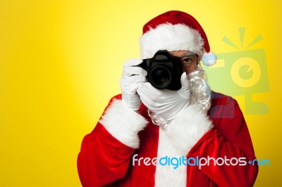 Say Cheese! Santa Capturing A Perfect Moment Stock Photo