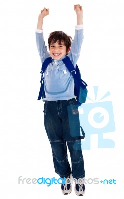 School Boy Raising His Arms In Joy Stock Photo