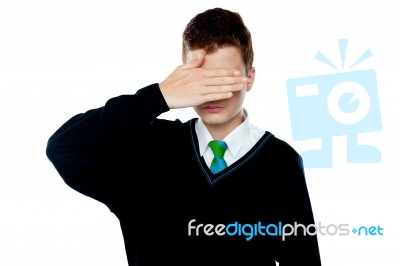 School Boy With Hand Over Eyes Stock Photo