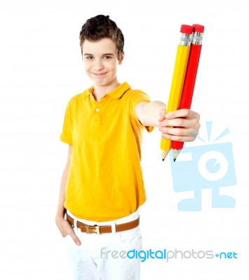 Schoolboy Showing Big Pencils Stock Photo