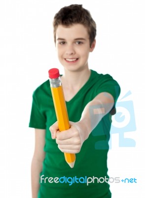 schoolBoy Showing Big Yellow Pencil Stock Photo
