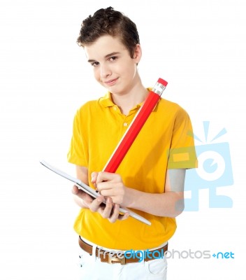 SchoolBoy Writing On Notebook Stock Photo