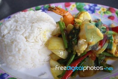 Seafood With Yellow Curry Sauce With Rice , Sauteed Seafood Contains Shrimp Squid, Stock Photo