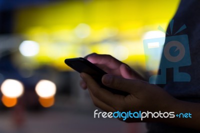 Selective Focus Hand Holding Phone On Night Stock Photo