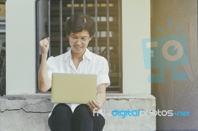 Senior Asian Woman Celebrate With Laptop Stock Photo