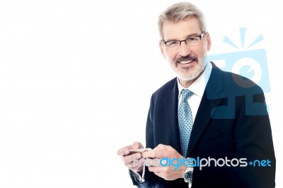 Senior Businessman Using A Cell Phone Stock Photo