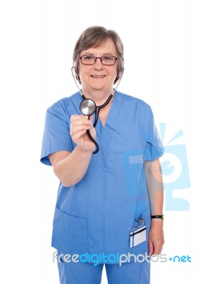 Senior Doctor Holding Stethoscope Stock Photo