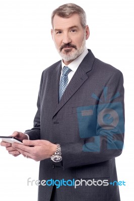 Senior Entrepreneur Using Smartphone Stock Photo