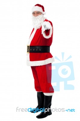 Senior Man In Santa Costume Pointing At You Stock Photo