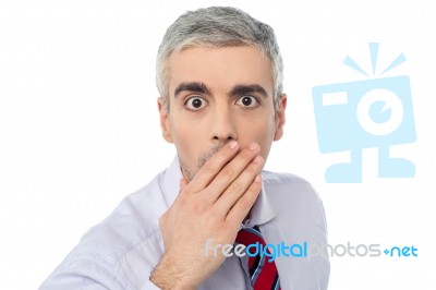 Senior Mature Man Closing Mouth With Hand Stock Photo