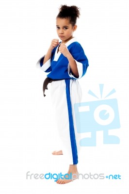 Serious Karate Girl With Her Fist In Foreground Stock Photo
