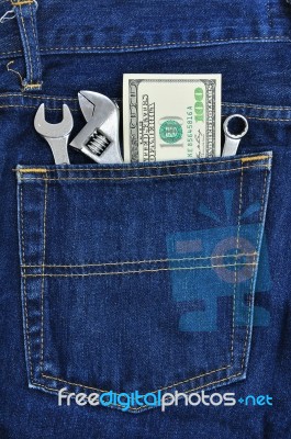 Several Tools And Dollar Banknote In Pocket Stock Photo