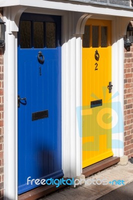 Shadow Approaching Blue And Yellow Doors Stock Photo