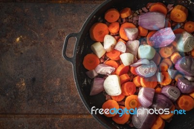 Shallot And Carrots In The Pan On The Metal Background Stock Photo