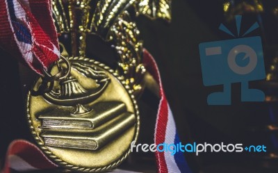 Shiny Golden Metal With Ribbon Red White And Blue Around It Stock Photo