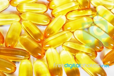 Shiny Yellow Fish Oil Capsule Pills Close Up Stock Photo