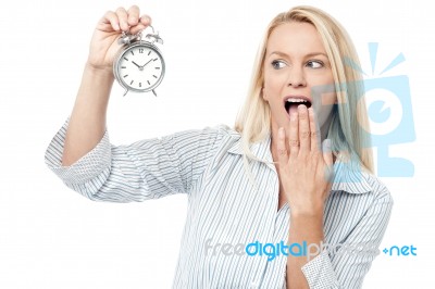 Shocked Woman Holding Alarm Clock Stock Photo