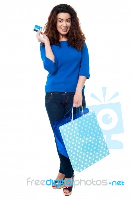 Shopaholic Woman Holding Shopping Bags And Credit Card Stock Photo