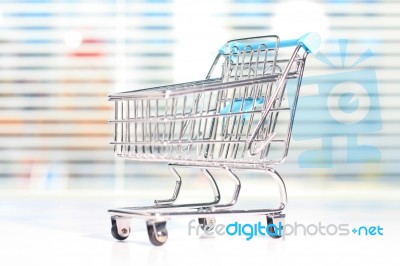 Shopping Cart On A White Table Stock Photo