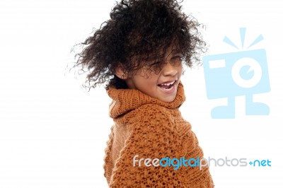 Shot Of Curly Haired Girl Having A Great Time Stock Photo