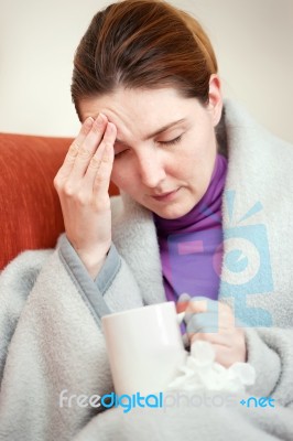 Sick Woman Covered With Blanket At Home Stock Photo
