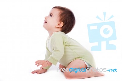 Side Pose Of Baby Sitting And Looking Up Stock Photo