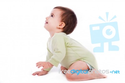 Side Pose Of Baby Sitting And Looking Up Stock Photo