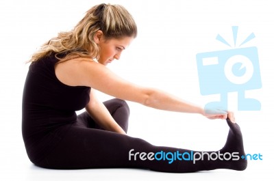 Side Pose Of Exercising Female Stock Photo